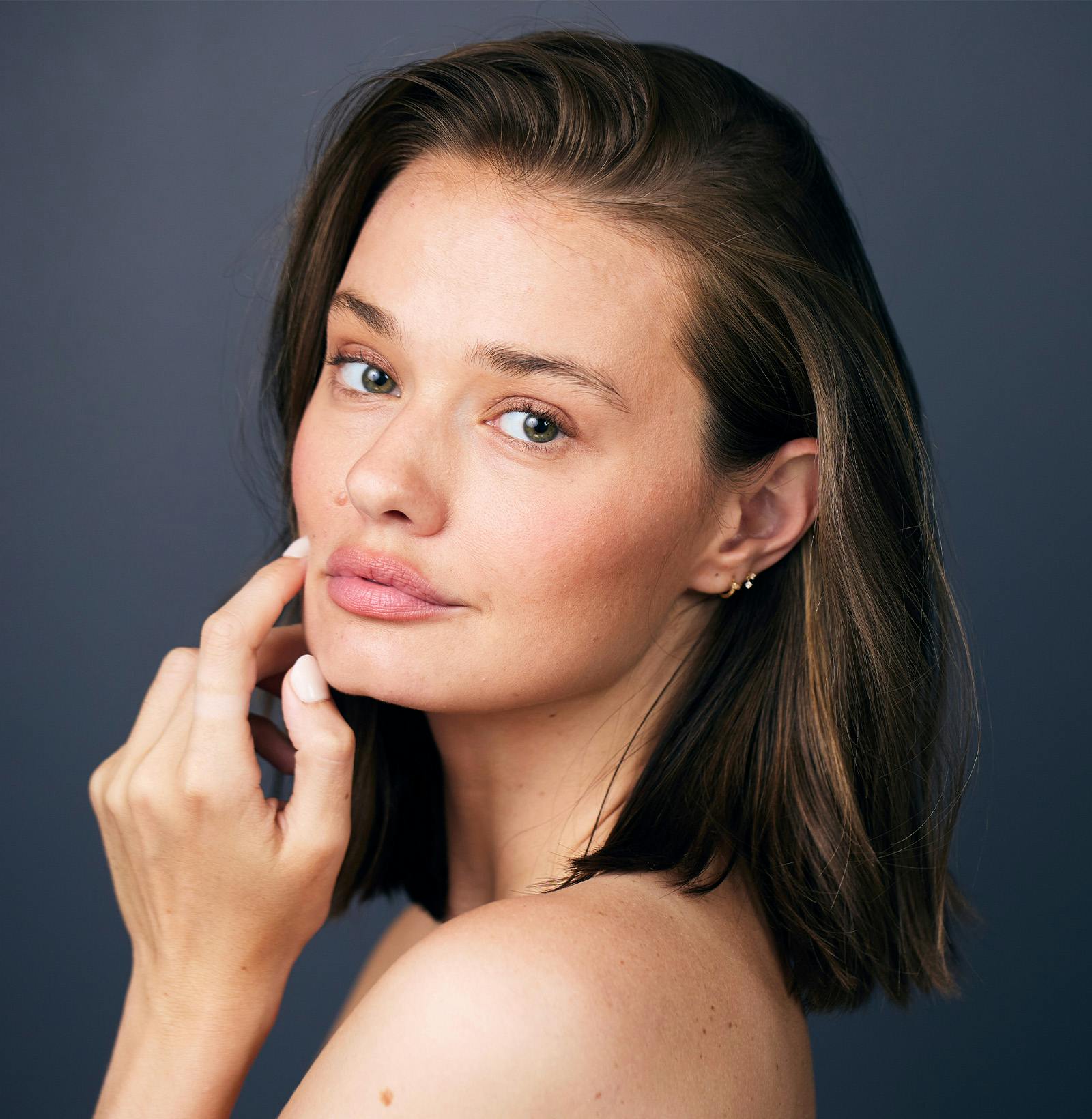 side view of a dark haired woman's face