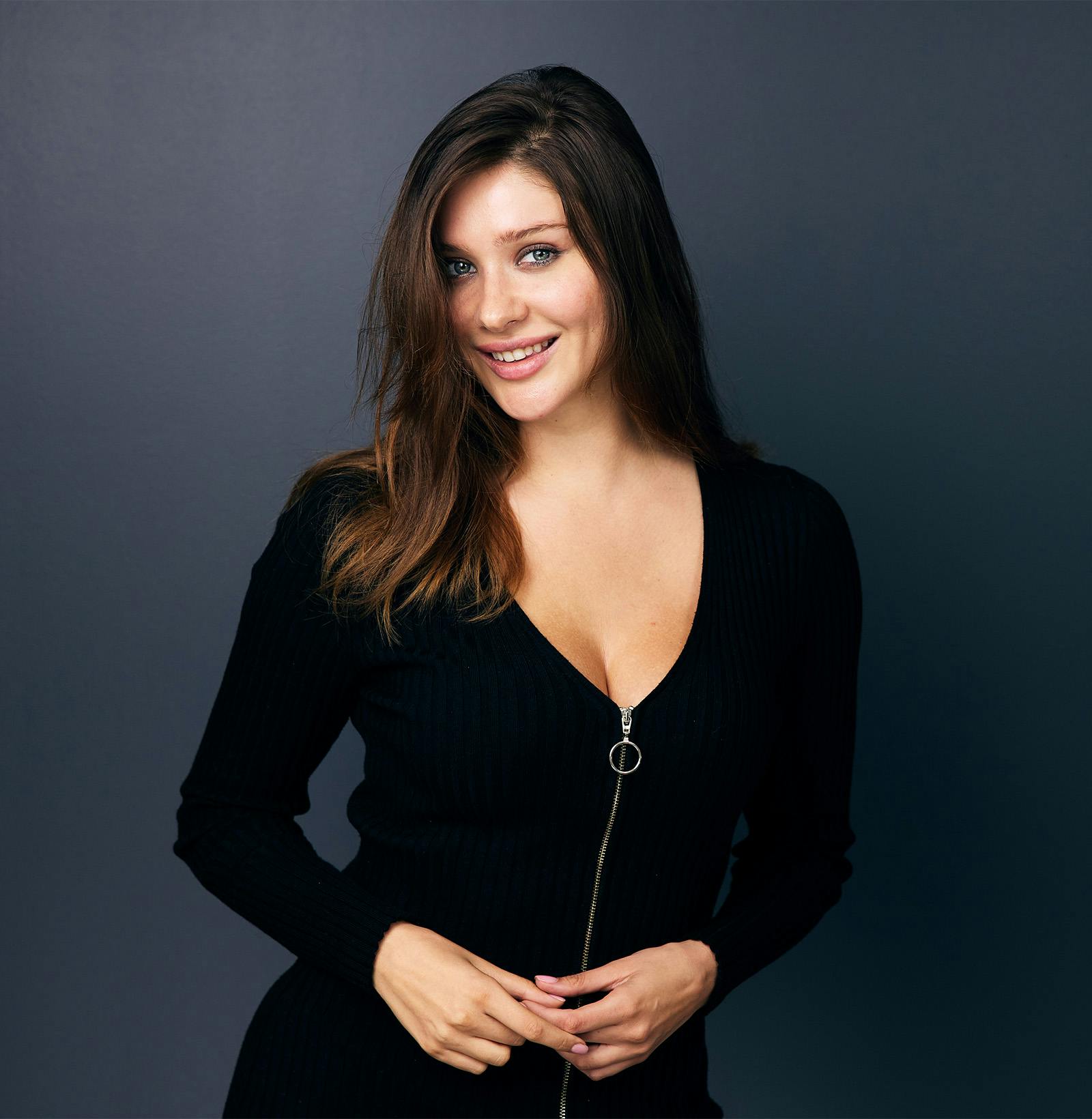 close up of dark haired woman smiling with her teeth shown