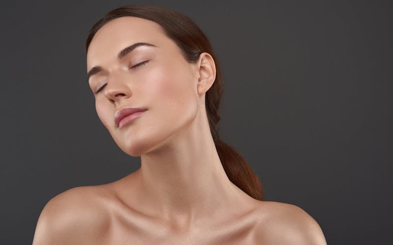 model with dark hair in a low ponytail