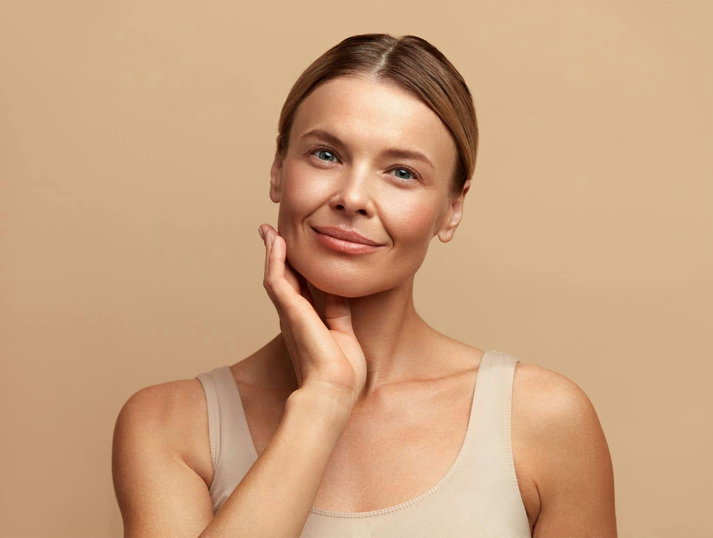 woman looking forward with her hand near her jaw