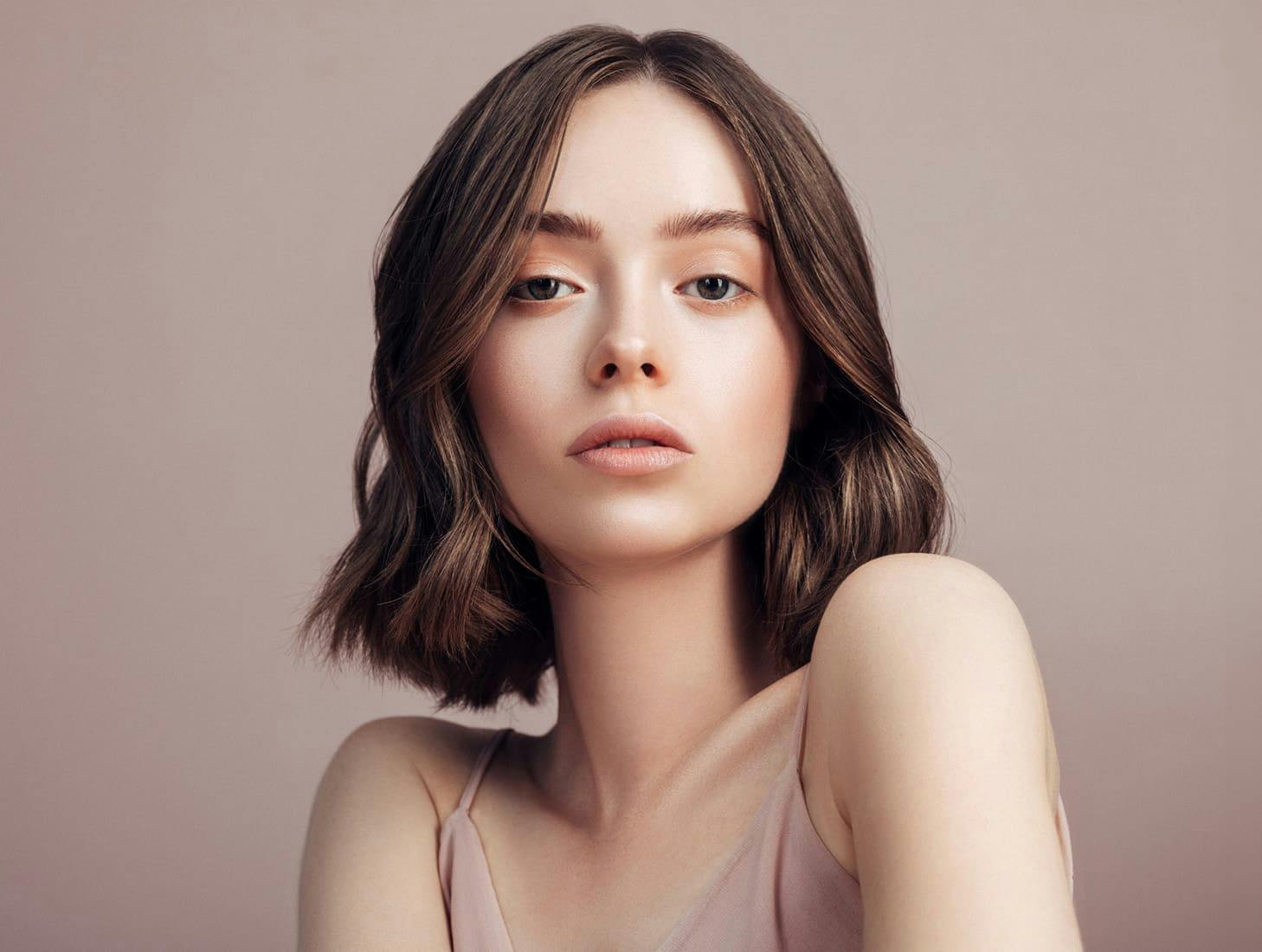 woman with a short brunette bob looking forward