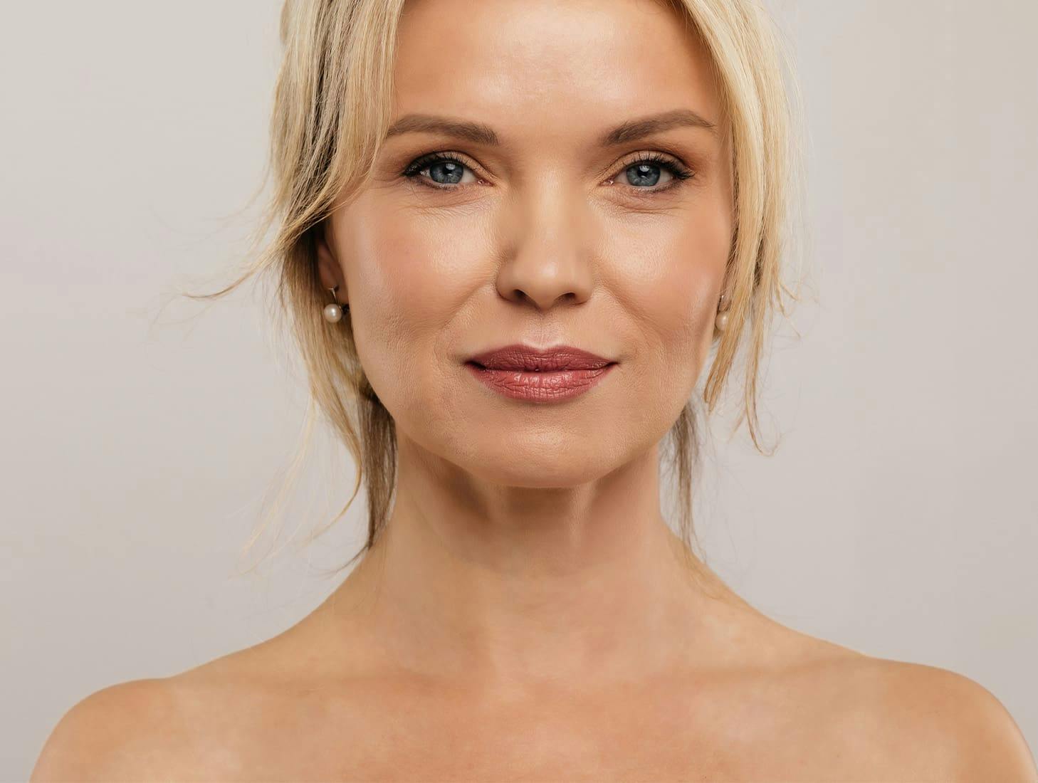woman facing forward with hair strands framing her face