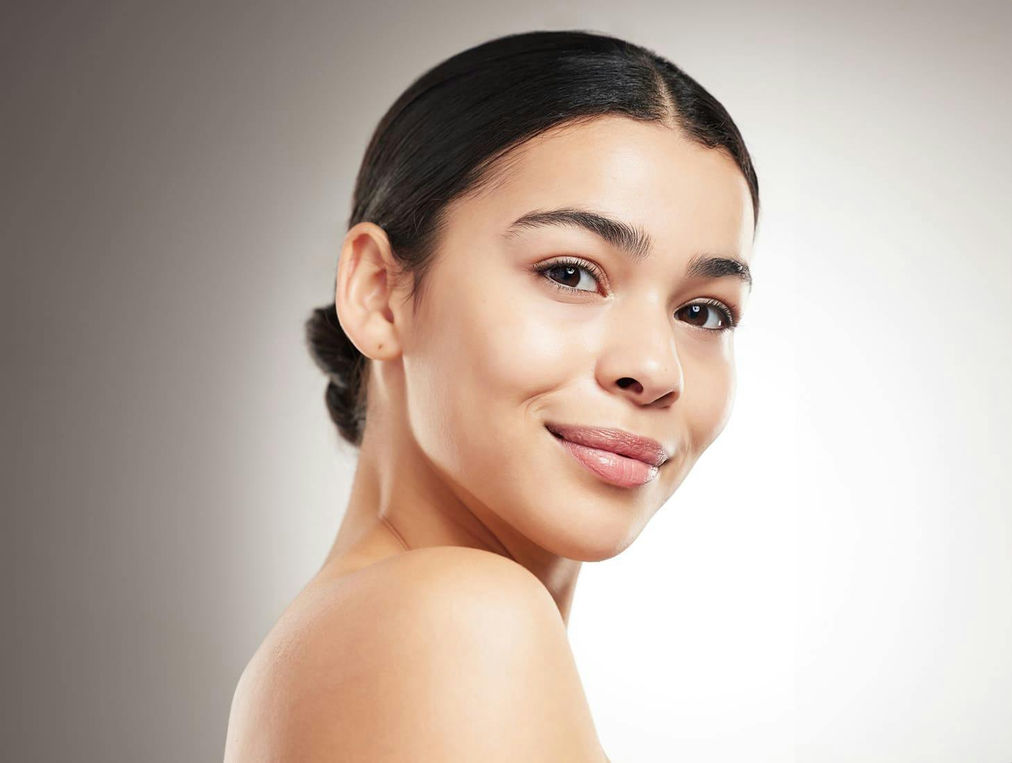 woman smiling with low bun in her hair