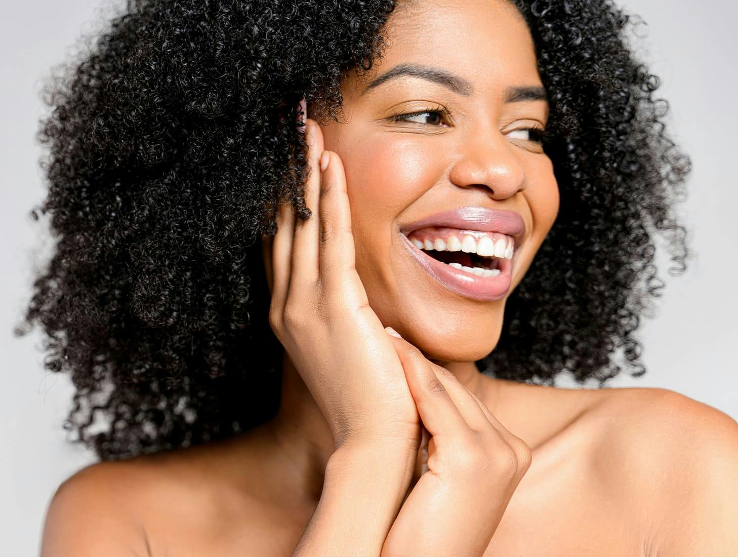 woman smiling with curly afro