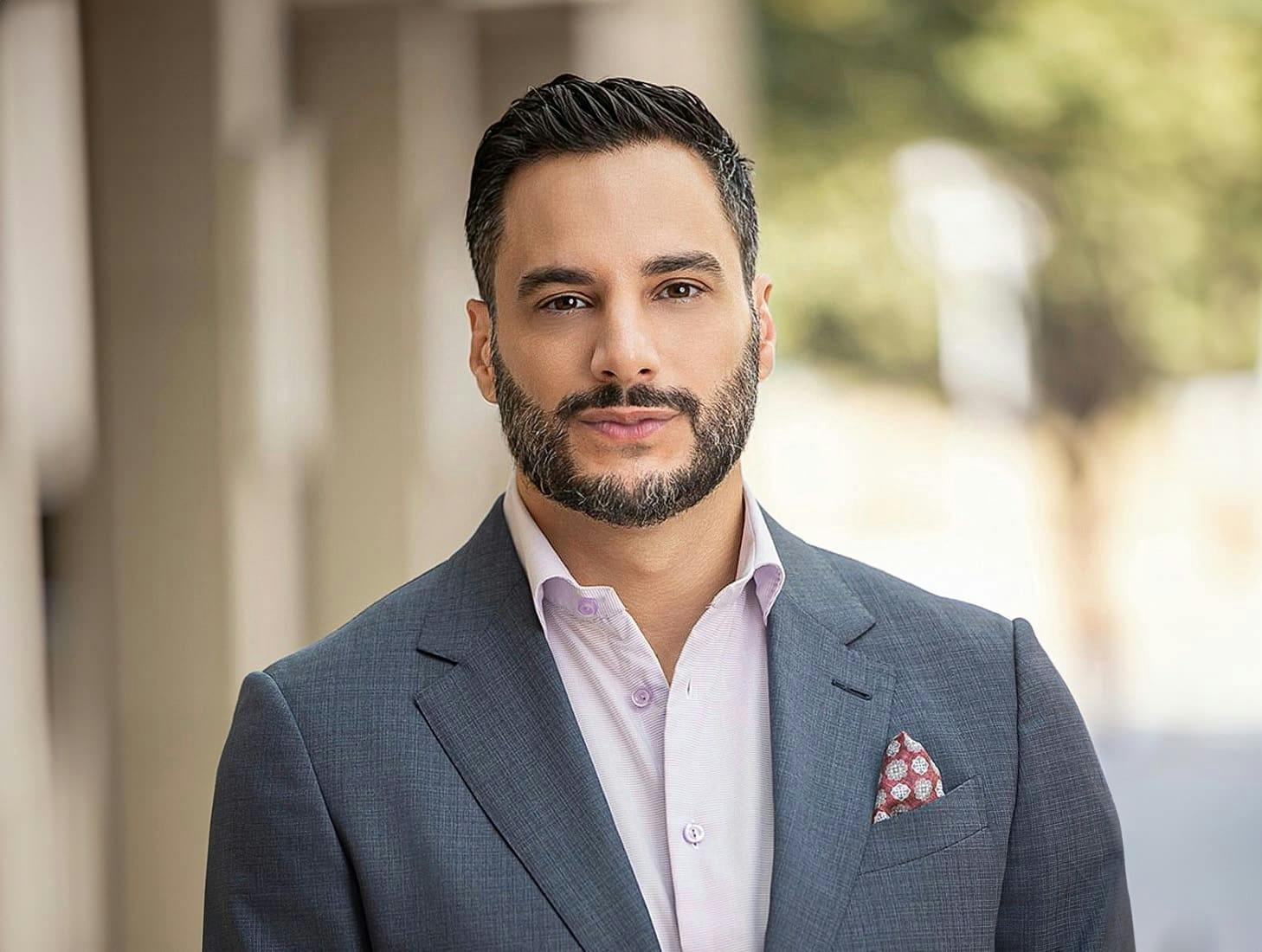 Dr. Louis Degironemo in gray suit