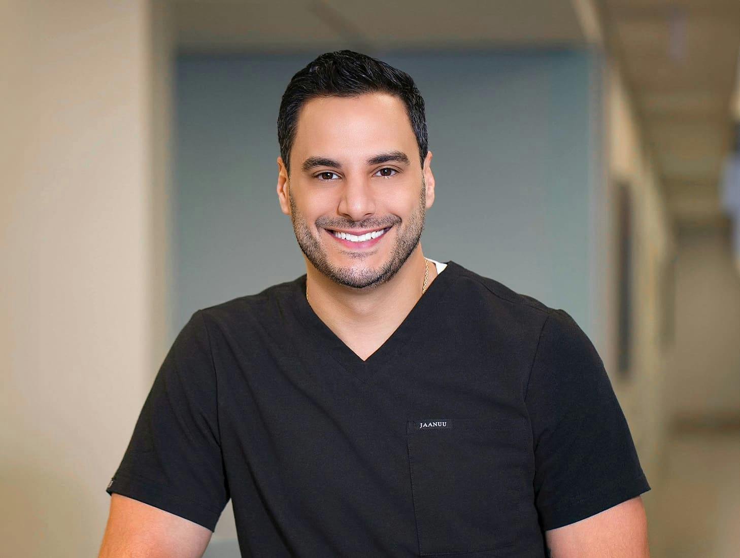 Dr. Louis Degironemo smiling in black shirt