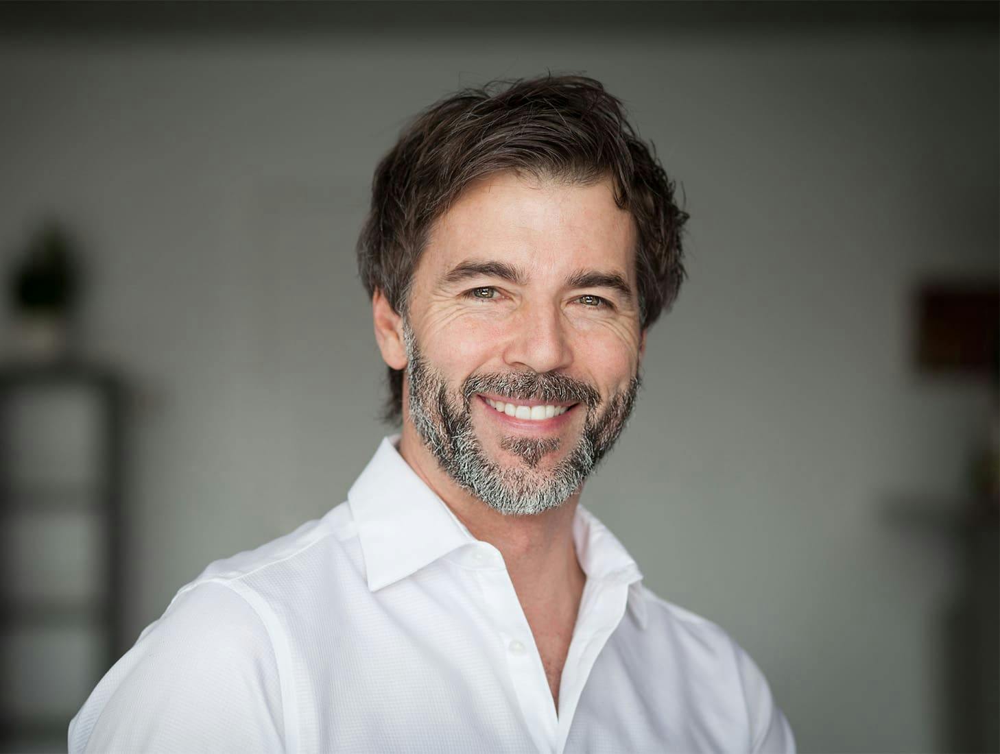 man smiling in white shirt