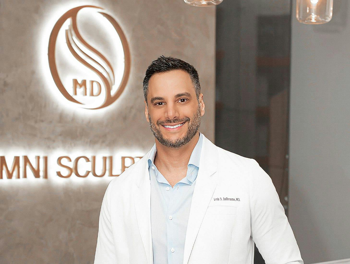 Dr. Louis Degironemo smiling in his doctor attire