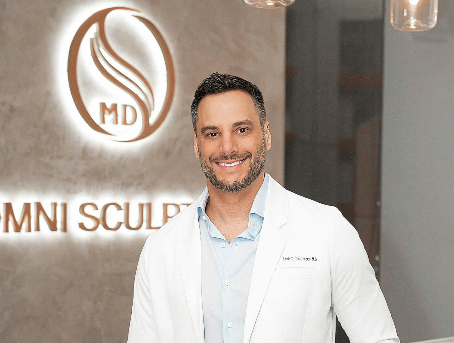 Dr. Louis Degironemo standing in front of Omni Sculpt sign