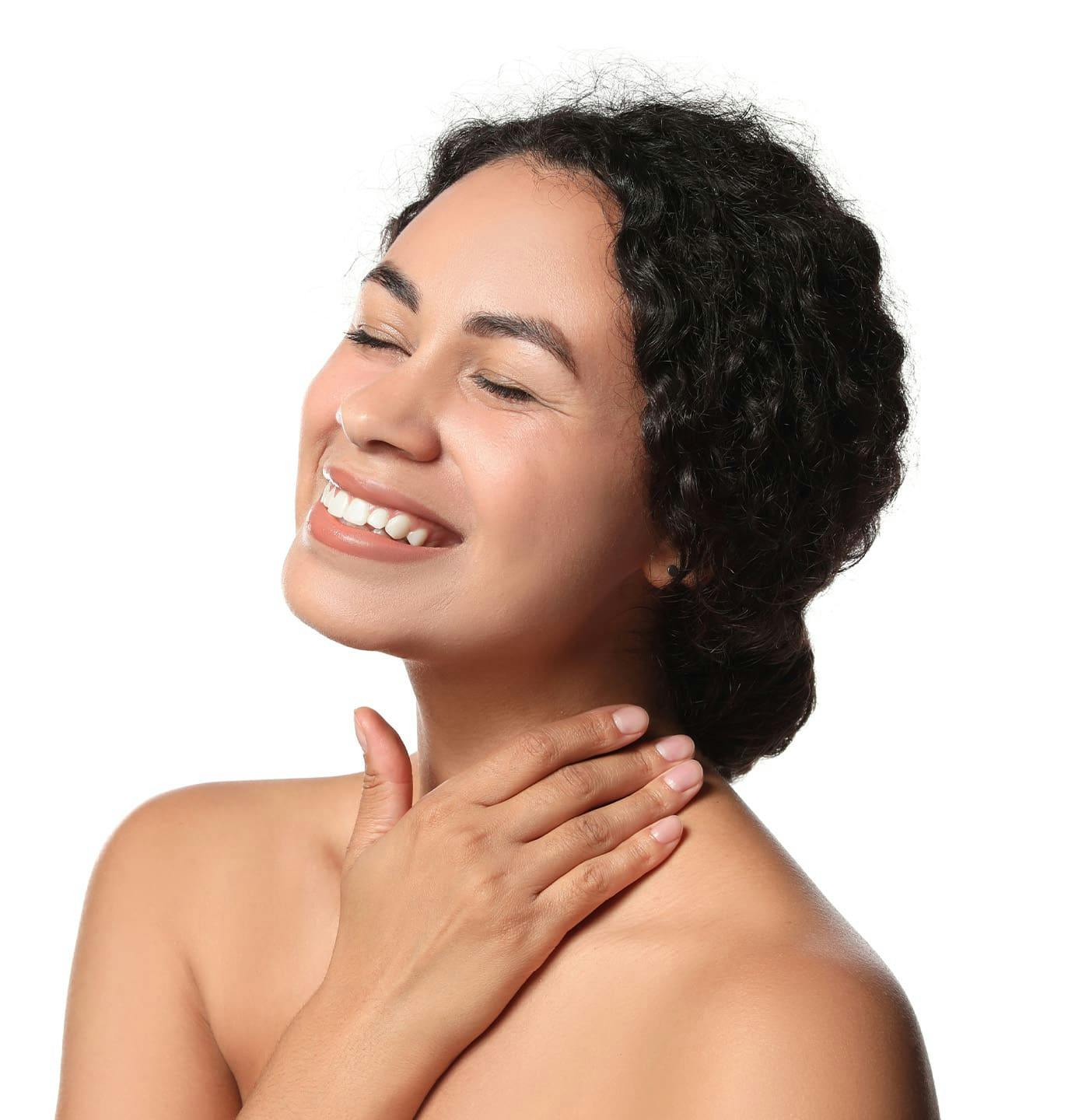 woman smiling with her hand on her neck