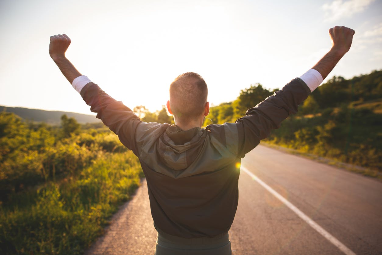 man raising his hands