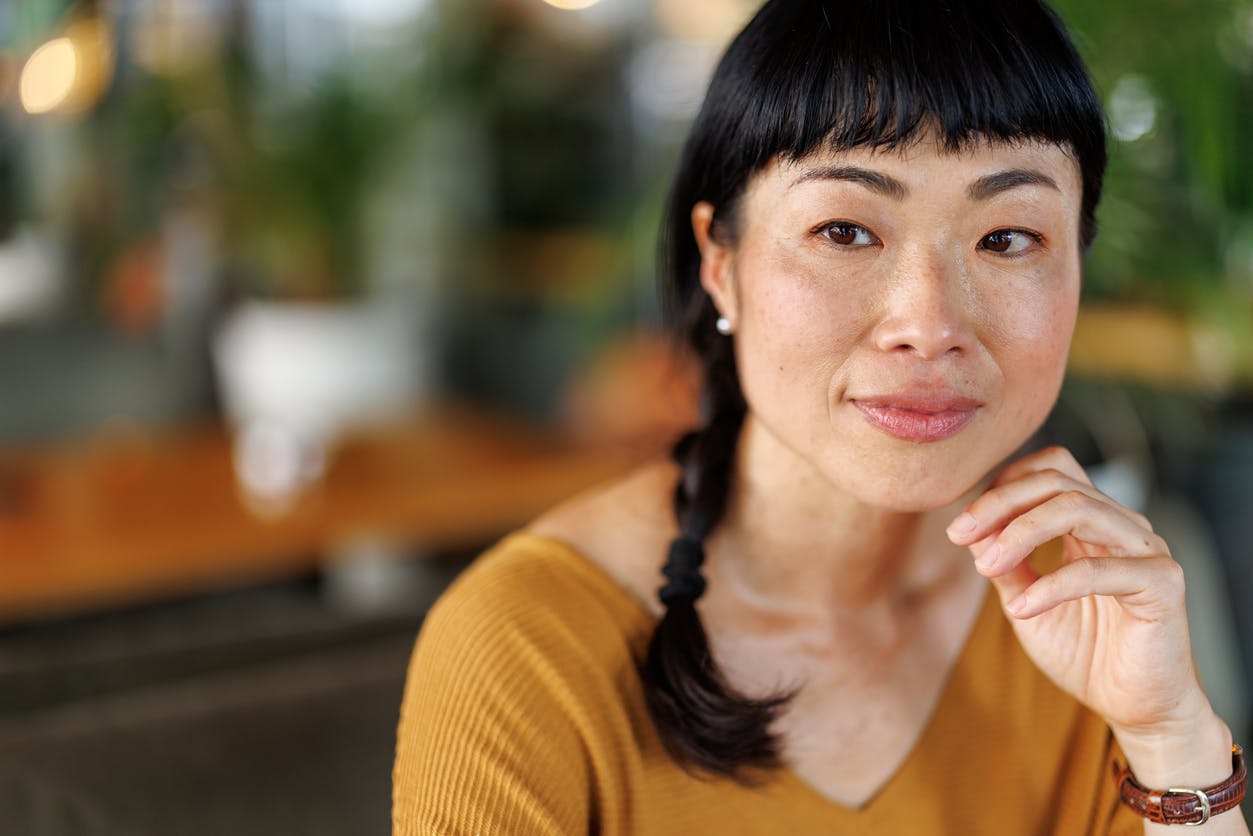 middle aged woman in a yellow sweater