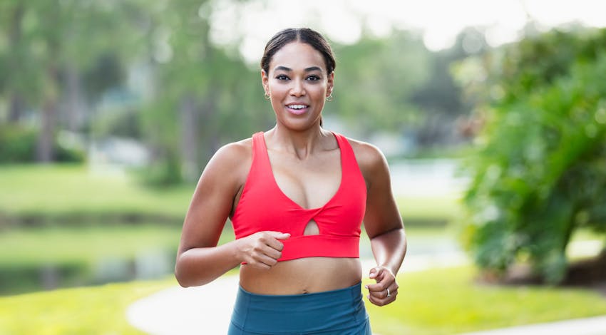 woman running in red sports bra