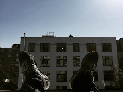 Person relaxing on office balcony.