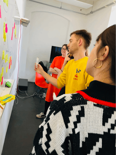 A designer and three developers using post-its on a whiteboard for sprint planning.