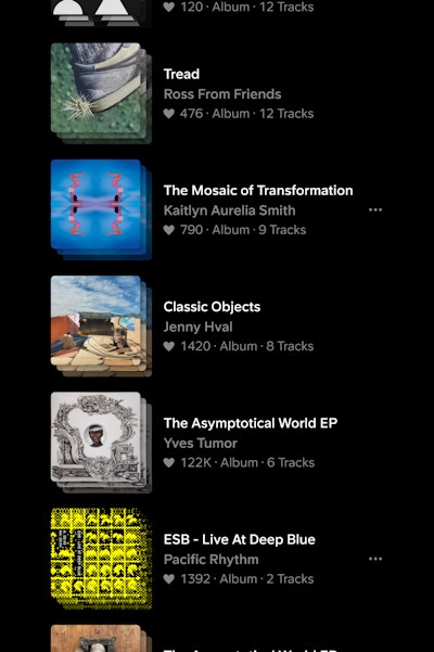 List of album cards stacked vertically in dark mode