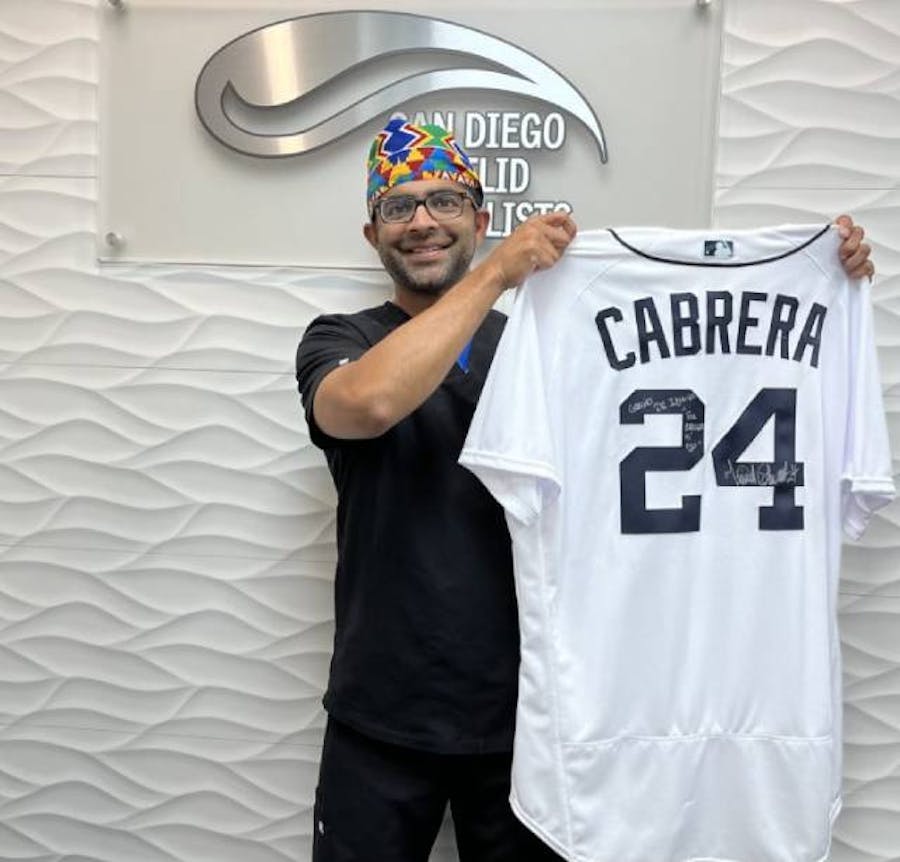 Dr. Iyengar holding a Cabrera jersey