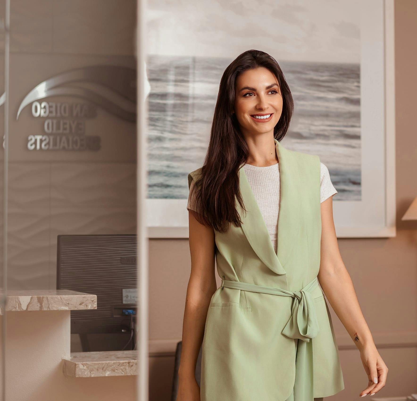 Woman smiling indoors with modern décor background