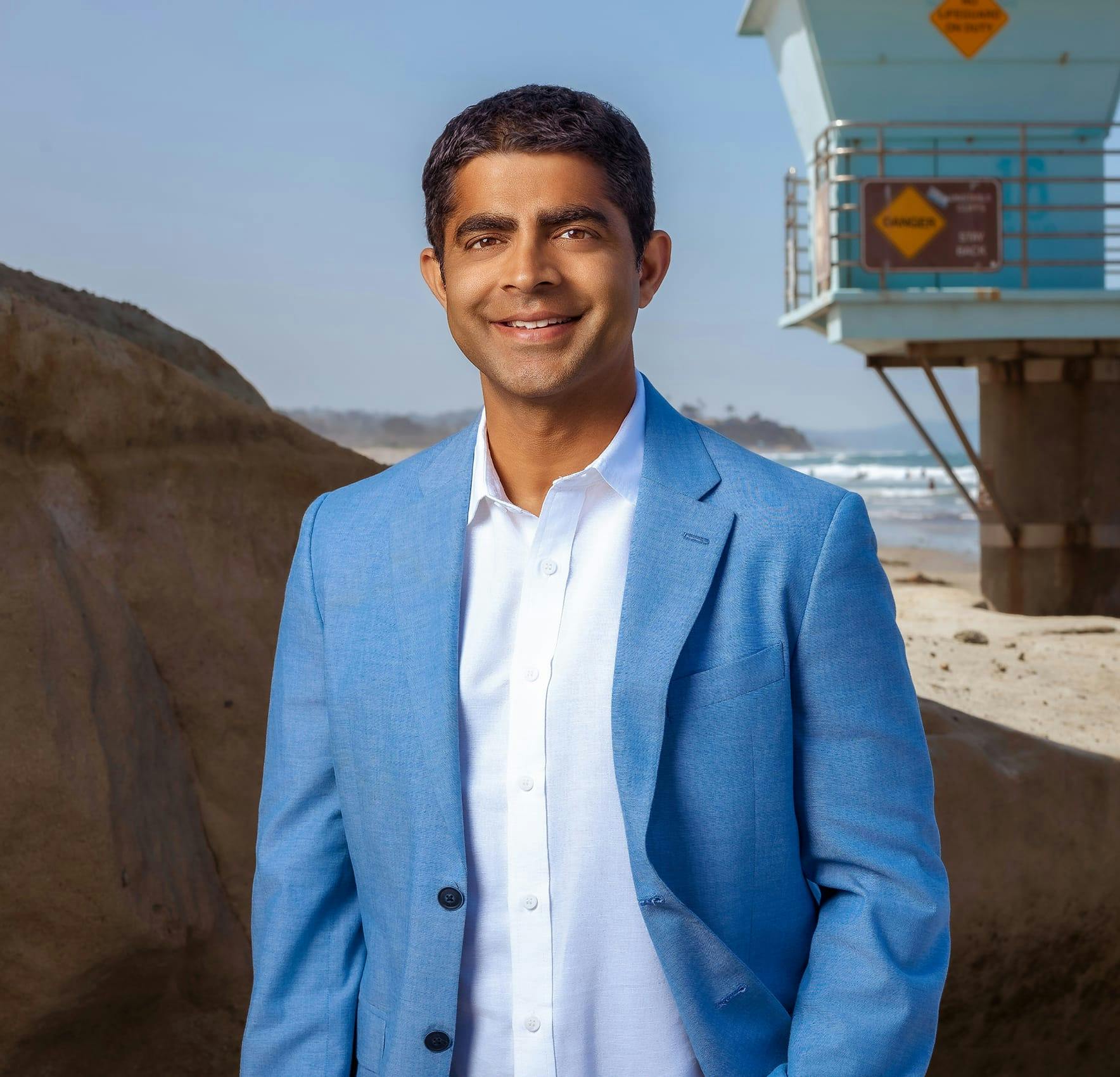 Smiling man standing near the beach