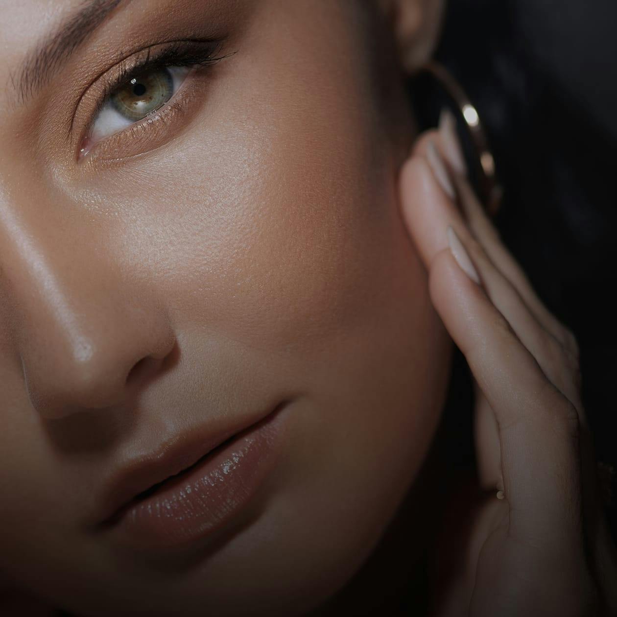 Closeup of a woman touching her face