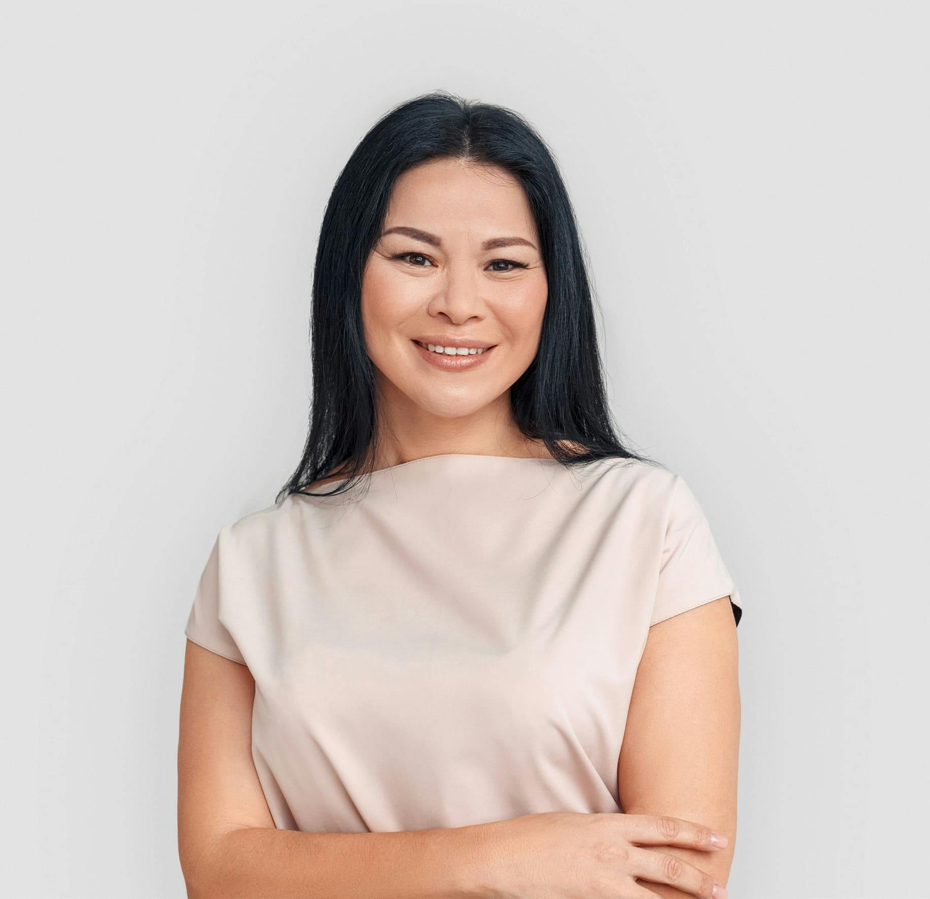woman smiling with her arms crossed