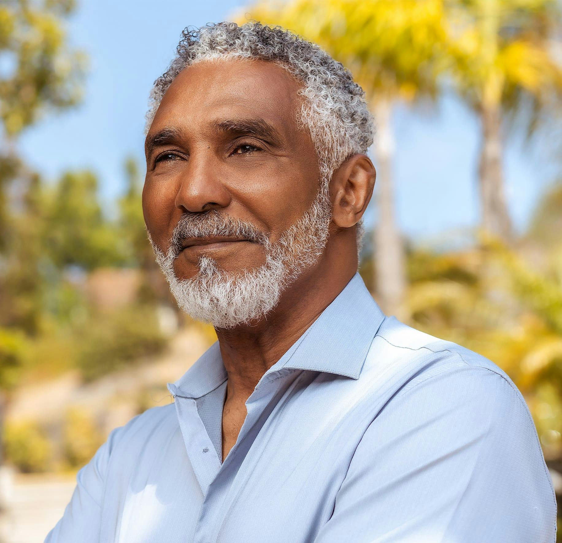 older man outside in white button up shirt