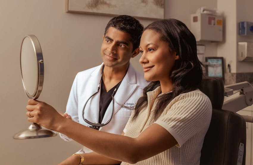 Dr. Iyengar and patient looking through mirror