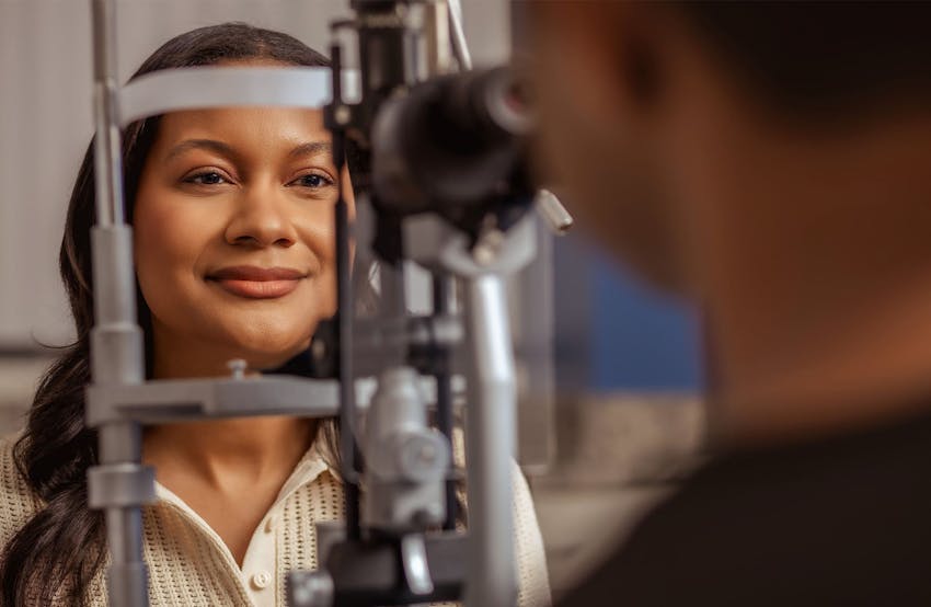 patient with her head in the eye examining machine