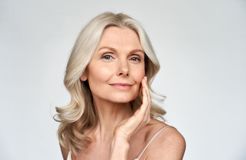 woman touching her cheek