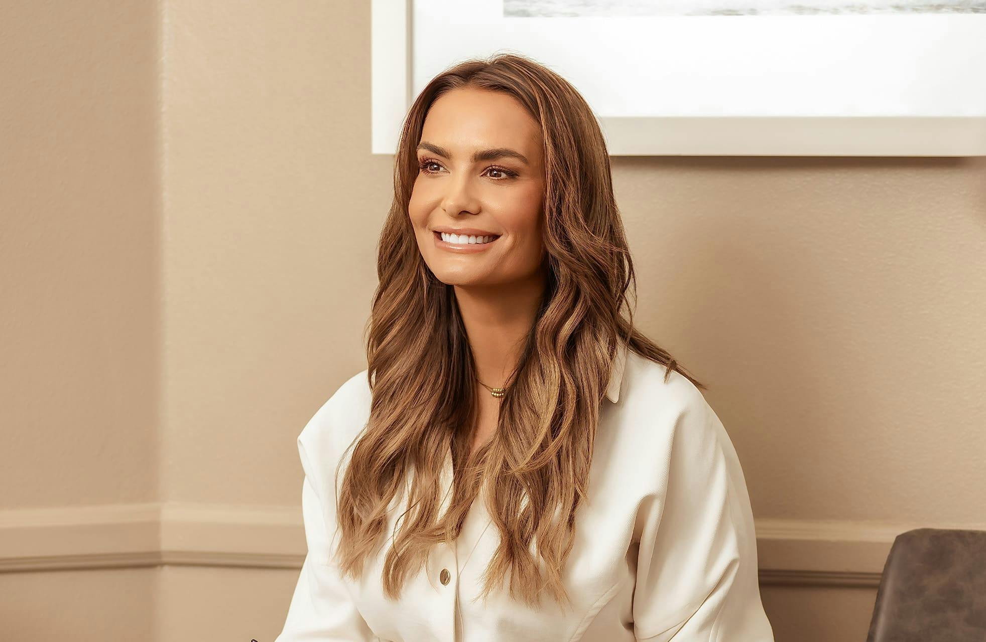 woman smiling and sitting down