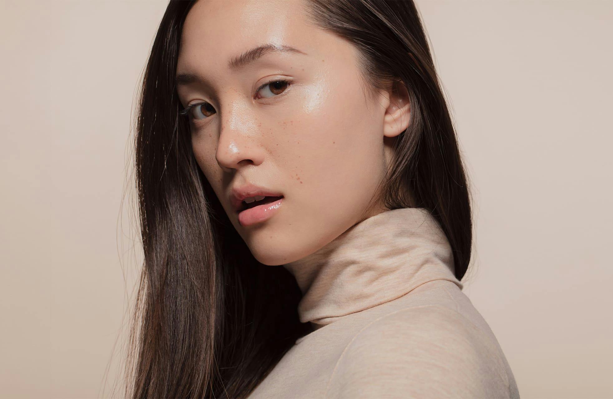 woman looking over her shoulder with her mouth slightly open