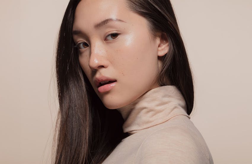 woman looking over her shoulder with her mouth slightly open