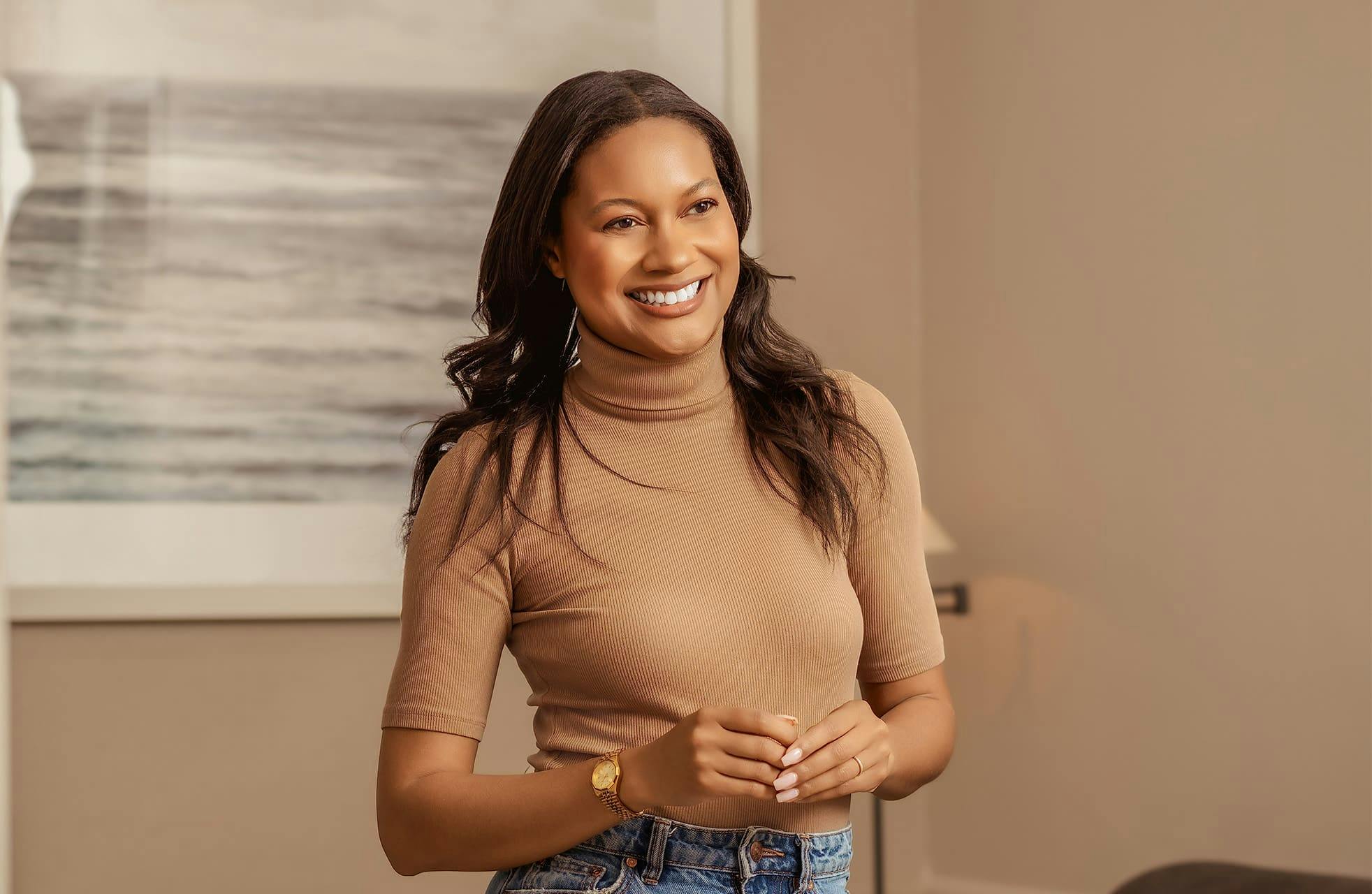 woman smiling with her hands together