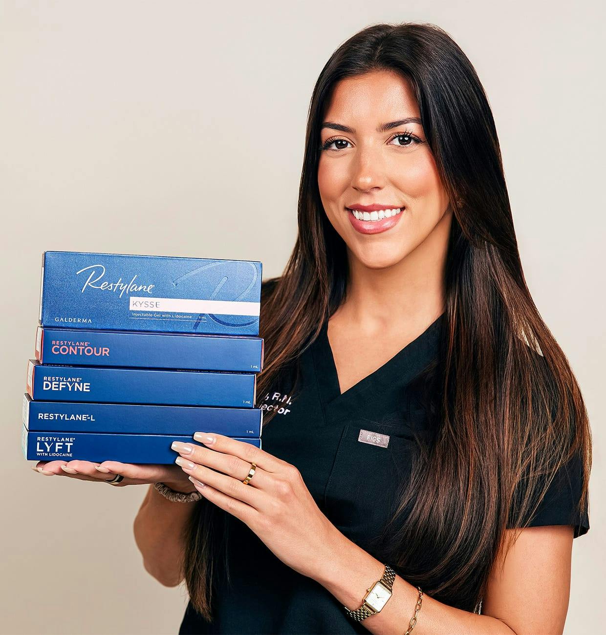 female staff holding mutliple boxes of facial fillers