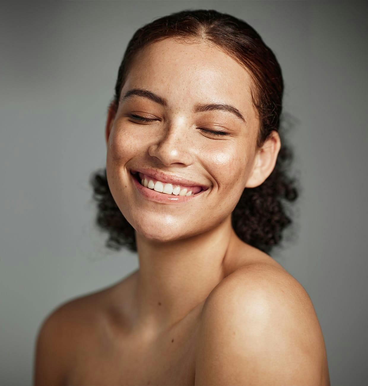woman with freckles smiling
