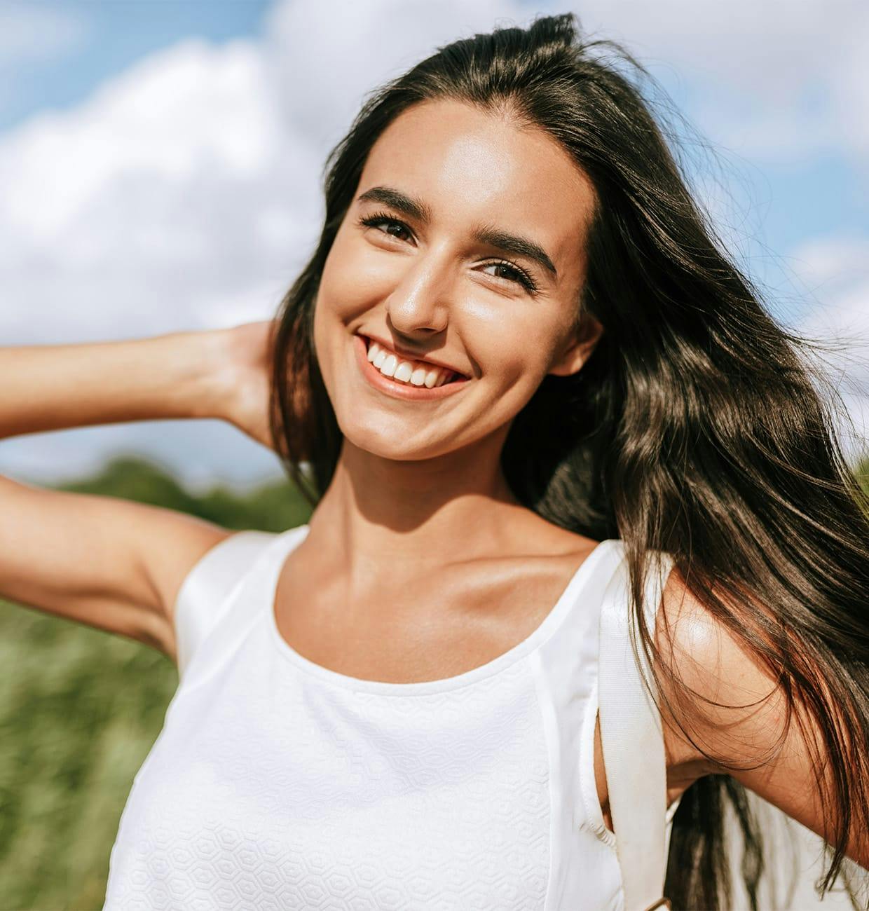 woman with long dark hair smiling