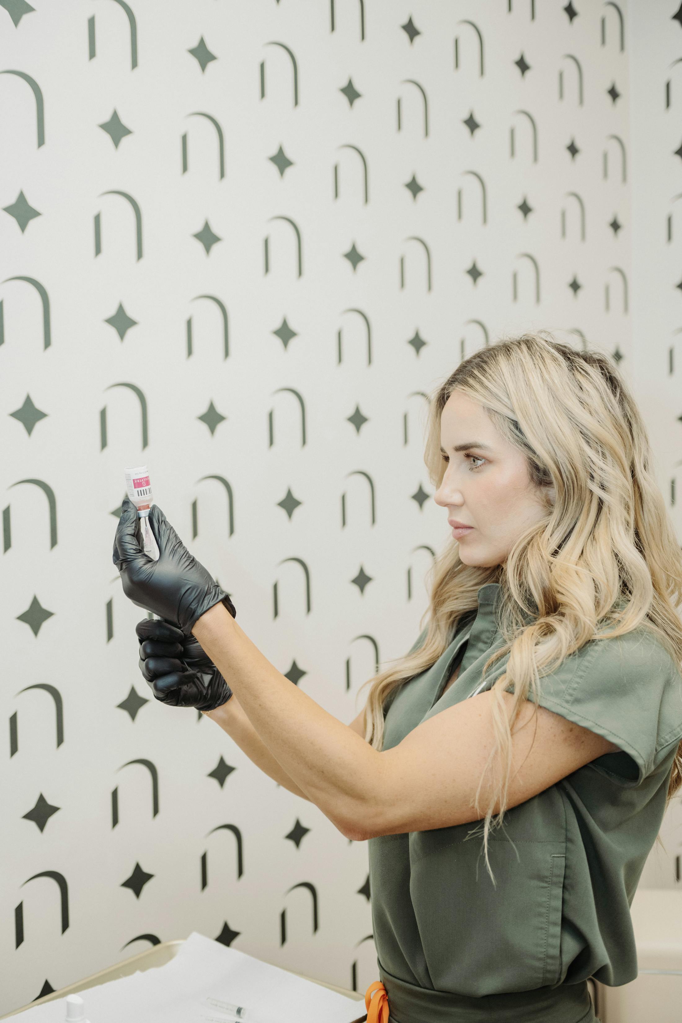woman taking liquid out of vial