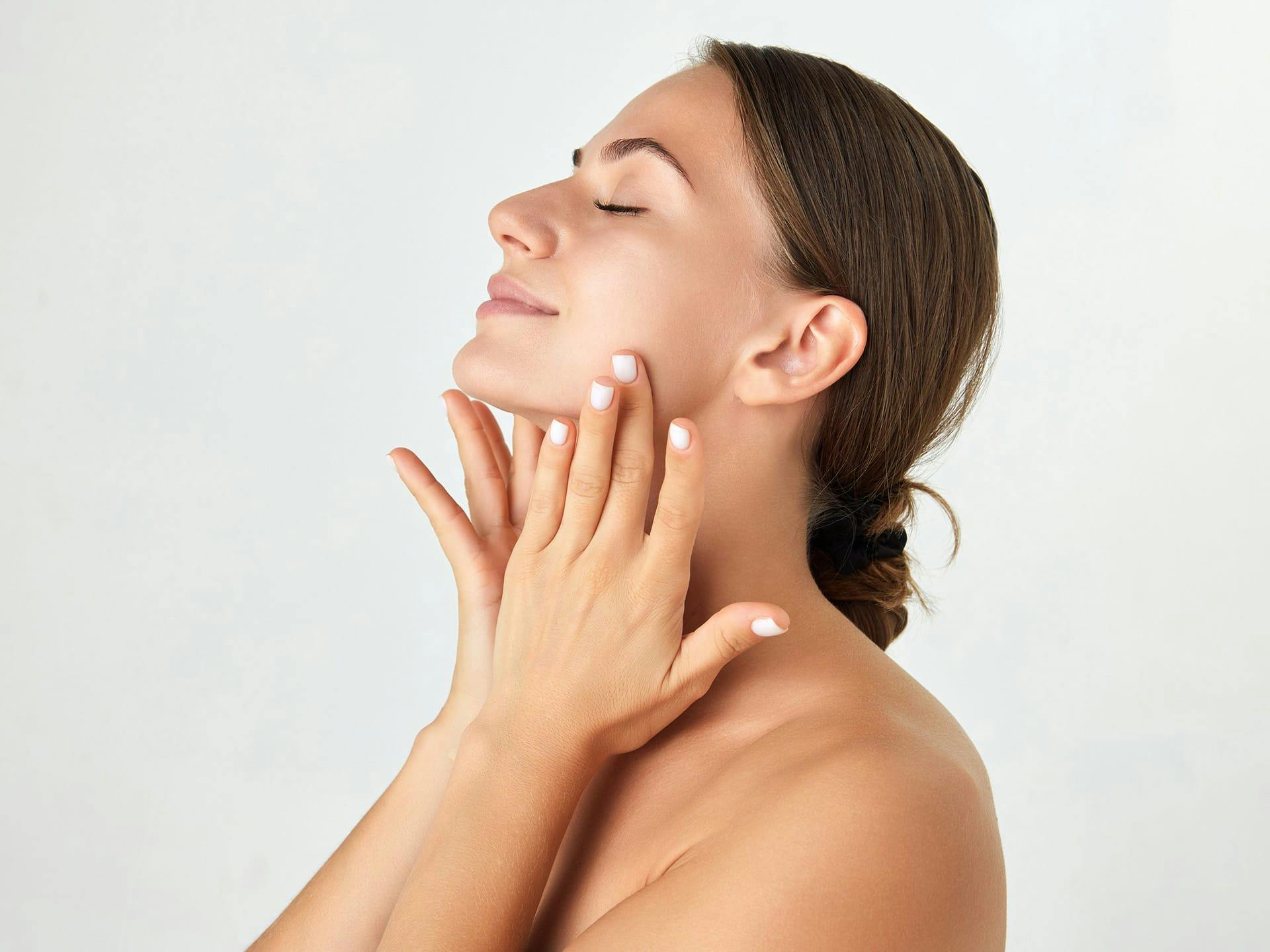 woman touching her neck