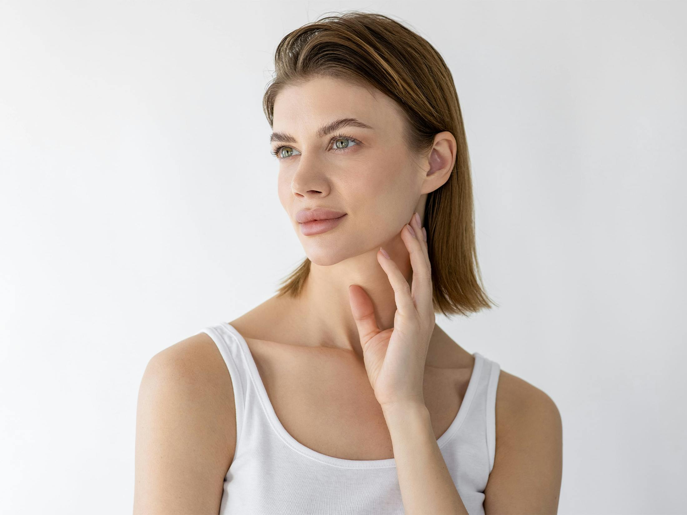 woman touching her neck