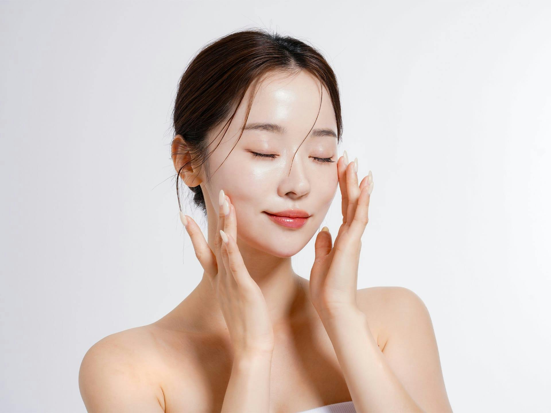 woman touching her face