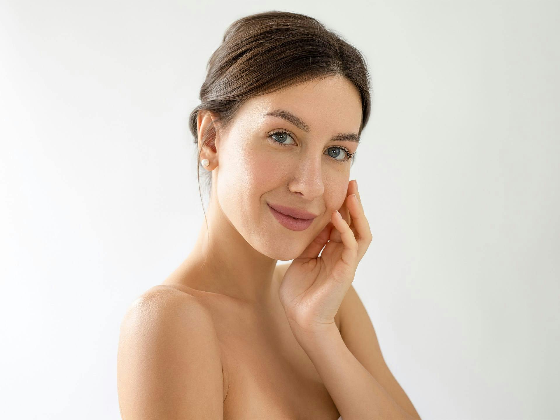 woman touching her face