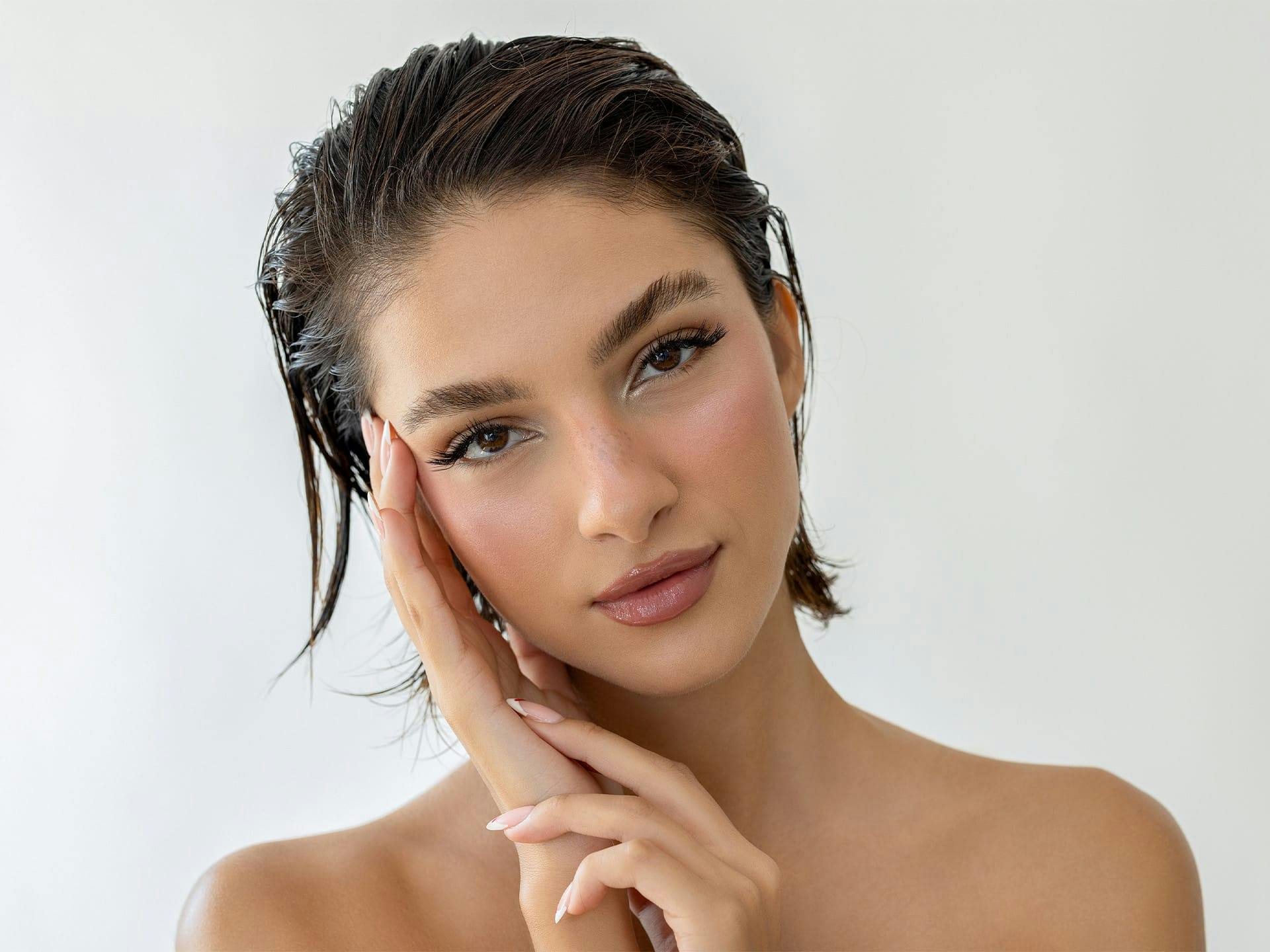 woman touching her face