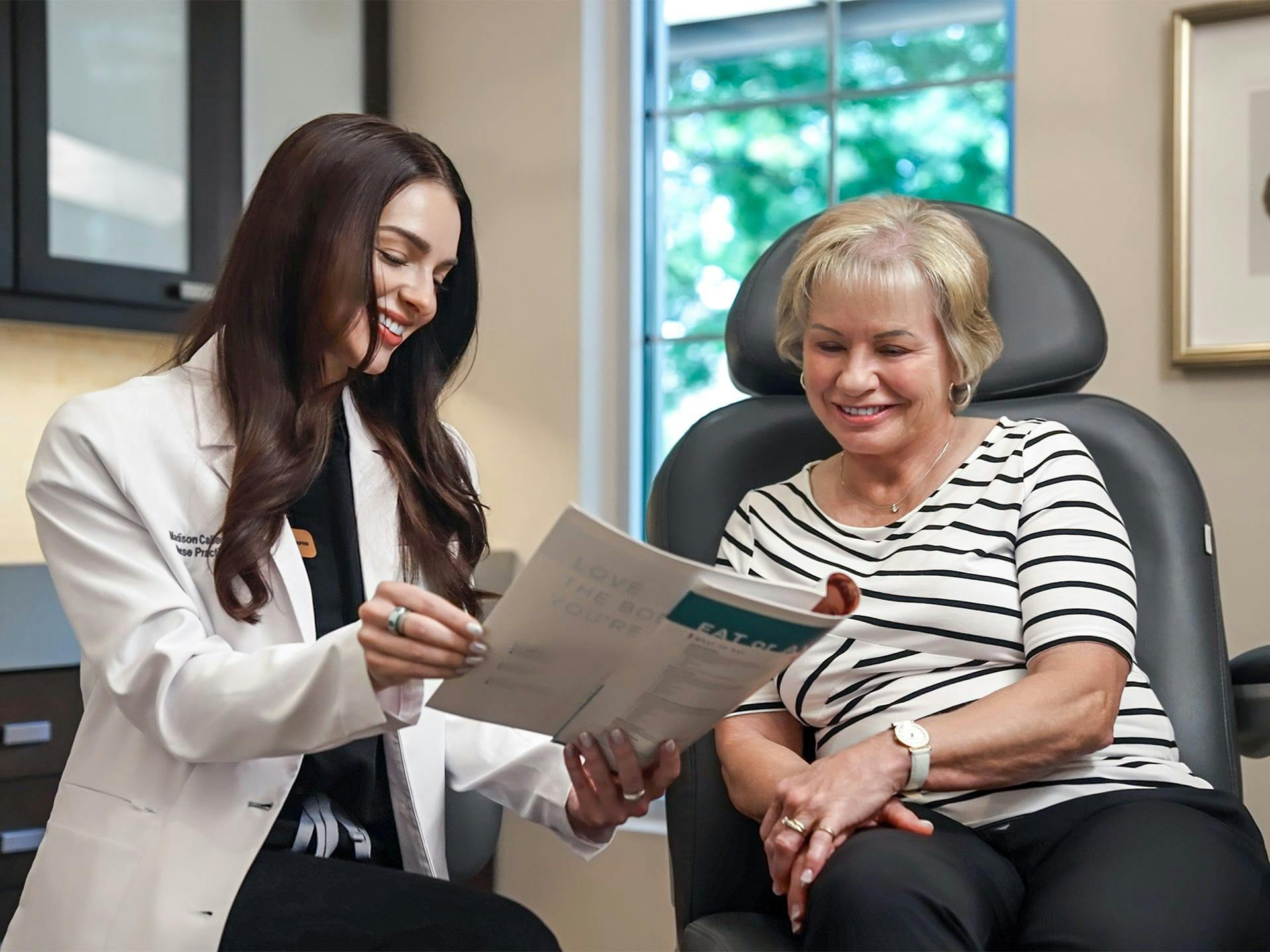 doctor showing a patient a pamphlet