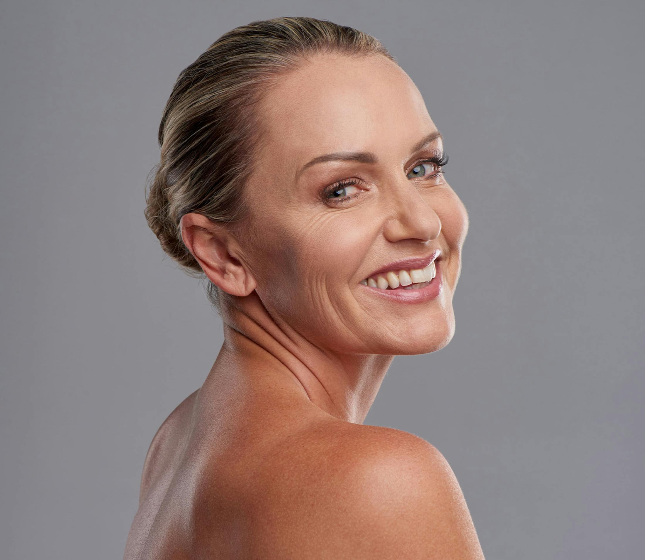 woman smiling and looking over her shoulder