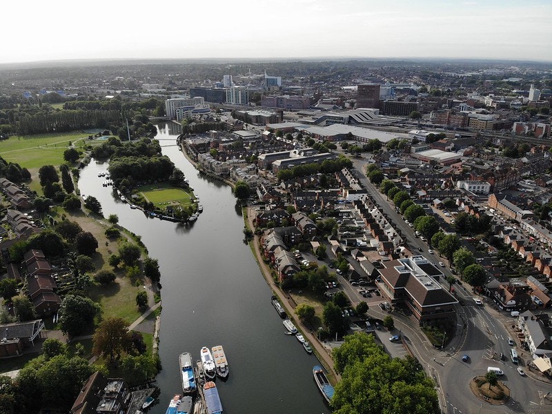 This image may contain: landscape, nature, outdoors, scenery, building, aerial view, urban, person, neighborhood, water