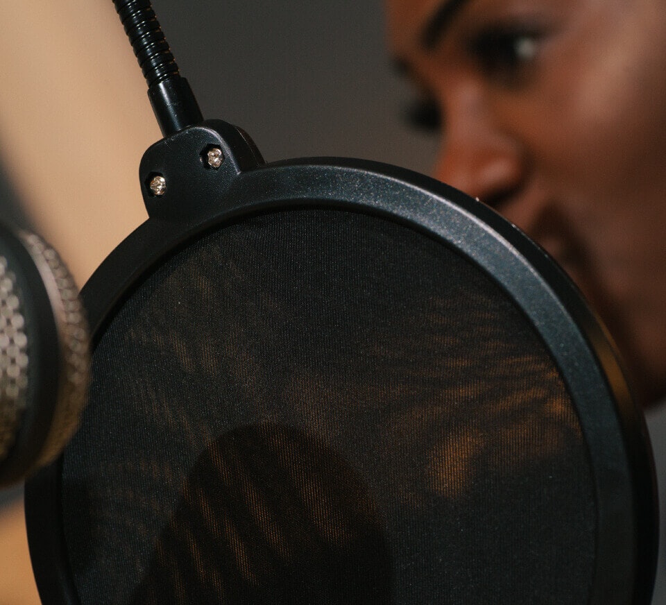 Close up shot of a RØDECaster Pro microhphone and podcaster inside Pirate Studios podcast studios. Podcast production services with crystal-clear audio — book today.