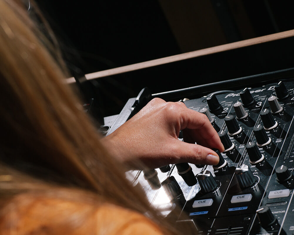 DJ using Pioneer CDJs and mixer inside DJ studios. DJ studio hire from Pirate Studios.