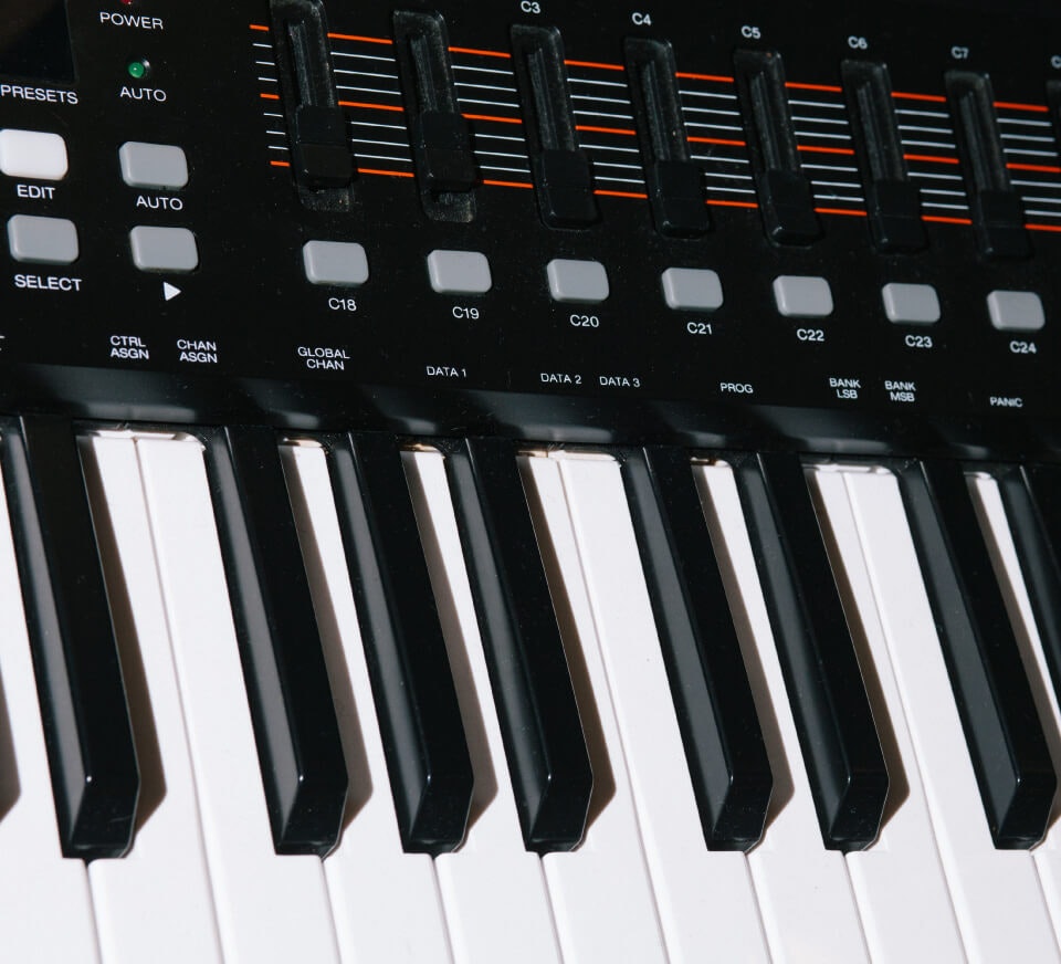 A close-up of a MIDI keyboard that you will find inside our recording studios. 24/7 recording rooms available for music production and vocal capture.