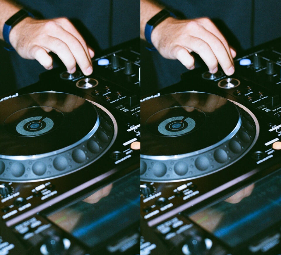 Close up shot of a DJ using a Pioneer DJM-900NXS2 and CDJ-2000NXS2 inside a Pirate Studios DJ studio