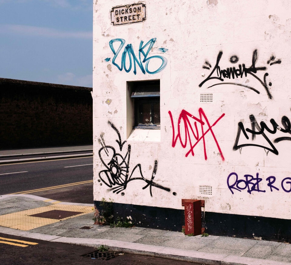 Graffiti adorning wall of Dickson Street, close to Pirate Studios Liverpool location